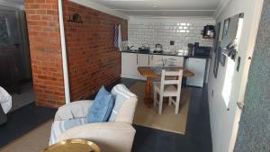 a small kitchen with a table and chairs in a room at Acorns and Quackers Self Catering in Underberg