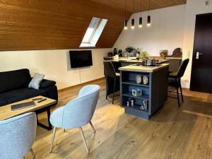 a living room with a couch and a table and chairs at Ferienwohnung am Brombachsee FeWo Horlacher in Pleinfeld