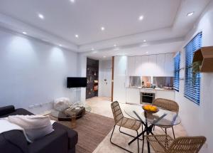 a living room with a couch and a table at Urban Oasis Darlinghurst in Sydney +15 photos