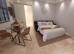 a bedroom with a bed and a glass table at Urban Oasis Darlinghurst in Sydney