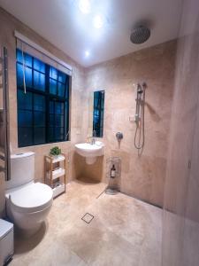 a bathroom with a toilet and a sink and a shower at Urban Oasis Darlinghurst in Sydney