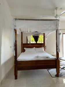 Ένα ή περισσότερα κρεβάτια σε δωμάτιο στο Mella Apartments Watamu