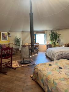 a room with a fireplace in a tent with a bed at Cortijo alhijra big yourte in Lanjarón