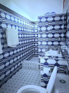 a bathroom with a toilet and a sink at Sweet Home in Kiwengwa