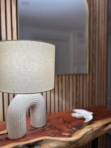 a lamp sitting on top of a wooden table at Apartamento LAS ABUBILLAS in Soria