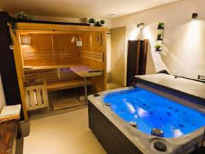 a bathroom with a large blue tub in a room at Škorničkův statek in Chlum u Třeboně