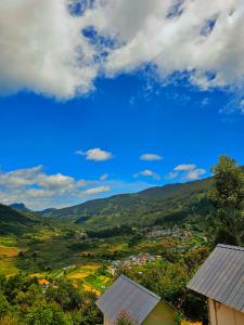 a view of a town in a valley with mountains at Tribano vattavada in Vattavada