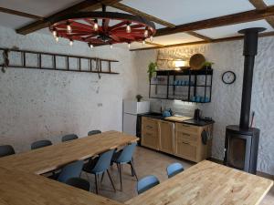 a kitchen with a table and chairs and a stove at Škorničkův statek in Chlum u Třeboně +71 photos