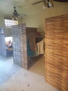 a room with a wooden wall and a table with towels at Sweden Inn Hostel Chalong in Ban Klang