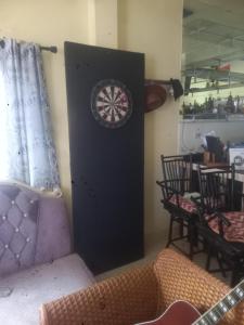 a black door with a dart board in a room at Sweden Inn Hostel Chalong in Ban Klang