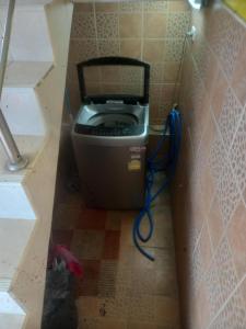 a trash can in a corner of a bathroom at Sweden Inn Hostel Chalong in Ban Klang