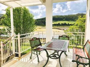 a patio with a table and chairs on a porch at The Cliffs - Esteiro Saltwater Beach in O Barqueiro