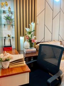 a bedroom with a desk and a chair with a book at Cozy and Stylish Studio at Inspiria with Balcony and City Views Free WiFi and Netflix beside Abreeza Mall in Davao City