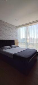 a large bed in a room with a large window at Joi Suites Hotel in Istanbul