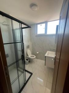 a bathroom with a toilet and a sink at Joi Suites Hotel in Istanbul