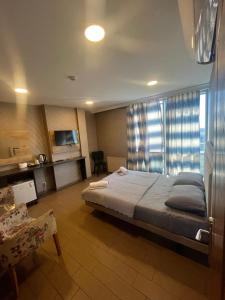 a bedroom with a large bed and a window at Joi Suites Hotel in Istanbul