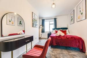 une chambre avec un lit avec un miroir et une chaise dans l'établissement 1 Bed Apartment Near Coop Live Etihad Stadium, à Manchester