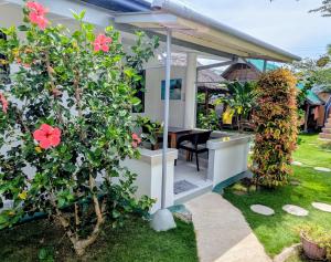 a view of a house with a garden at Astillo's Guest Houses in Moalboal