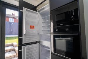 a refrigerator with its door open with its door openhaarhaar at The Scouse Suite in Liverpool