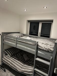 a bedroom with two bunk beds and a mirror at The Scouse Suite in Liverpool