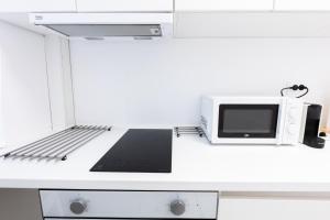 a microwave oven sitting on top of a counter at Lun Apartment in Cluj-Napoca +8 photos