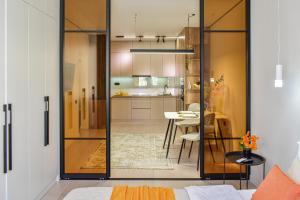 a room with a glass door leading to a kitchen at Auezov Apart in Almaty