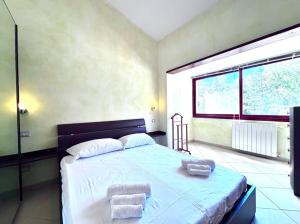 a bedroom with a large bed with towels on it at Villa Julien Quartu Sant'Elena Sardegna in Santa Luria