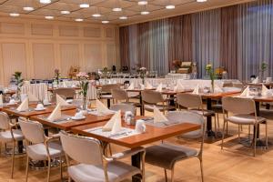 a conference room with tables and chairs and tablesktop at Hotel Pelikan in Schwäbisch Gmünd