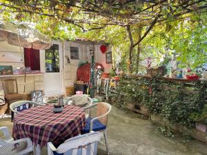 a table and chairs in a patio with a table and a table and chairsktop at Rosewood Balkan Cottage in Skopje