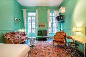 a bedroom with green walls and a bed and chairs at Pension Edelweiss Marseille in Marseille