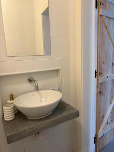 a bathroom with a white bowl sink on a counter at Monte da Rocha-Mãe in Barro Branco +16 photos