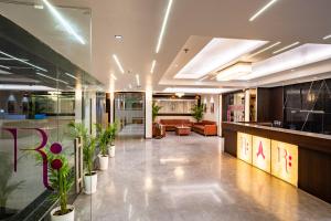 a lobby with potted plants in a building at Regenta Agra in Agra