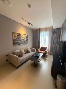 a living room with a couch and a coffee table at ودق للشقق المخدومة in Riyadh +20 photos
