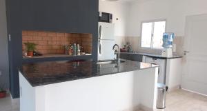 a kitchen with a sink and a counter top at Casa Tafí in Tafí Viejo