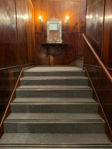 a staircase in a building with a mirror on the wall at The Royal Lodge in Beaufort West