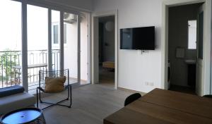 a living room with a couch and a tv on a wall at Peprina Apt 1 in Central Rabat in Rabat