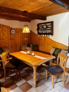 a dining room with a wooden table and chairs at Ferienhaus FRIEDLHOF in Langschlag