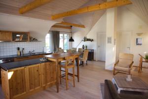 a kitchen and dining room with a table and chairs at Apartment with charm and dream view in Hosenruck