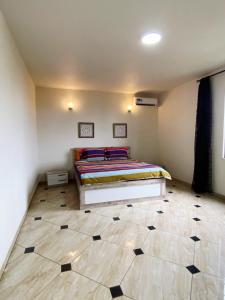 a bedroom with a bed and a tiled floor at Appartement luxe grand baie in Grand Baie +2 photos