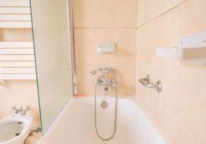 a bathroom with a shower and a toilet at Porto Surf Lodge in Porto +52 photos