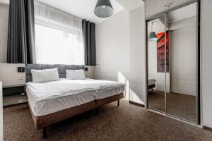 a bedroom with a bed and a large mirror at euroHOTEL Katowice Nikiszowiec in Katowice +35 photos