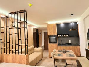 a living room with a couch and a table at UN lux - Residence Hill in Kopaonik