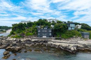 a house on a hill next to the water at Miura - House - Vacation STAY 19750 in Miura