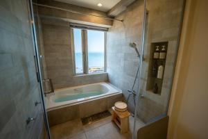 a bathroom with a bath tub and a window at Miura - House - Vacation STAY 19750 in Miura +76 photos