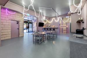 a dining room with tables and chairs and lights at UrbanKey Studio Hostel - Vienna Landstrasse in Vienna +21 photos