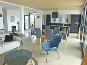 a living room with a couch and a table and chairs at Villa en el campo cerca de la playa in Armentera