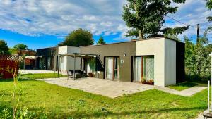 a small house with a patio in the yard at Domki Pasieka Domek D in Przeczyce