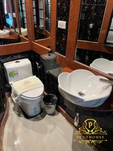 a bathroom with a toilet and a sink at PENTHOUSE PATTAYA in Pattaya
