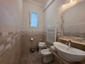 a bathroom with a sink and a toilet and a mirror at 200m from Beach, New Central Apt, AC, WiFi in Loano +19 photos