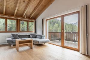 a living room with a couch and a table at Apart Jil-Marie in Samnaun